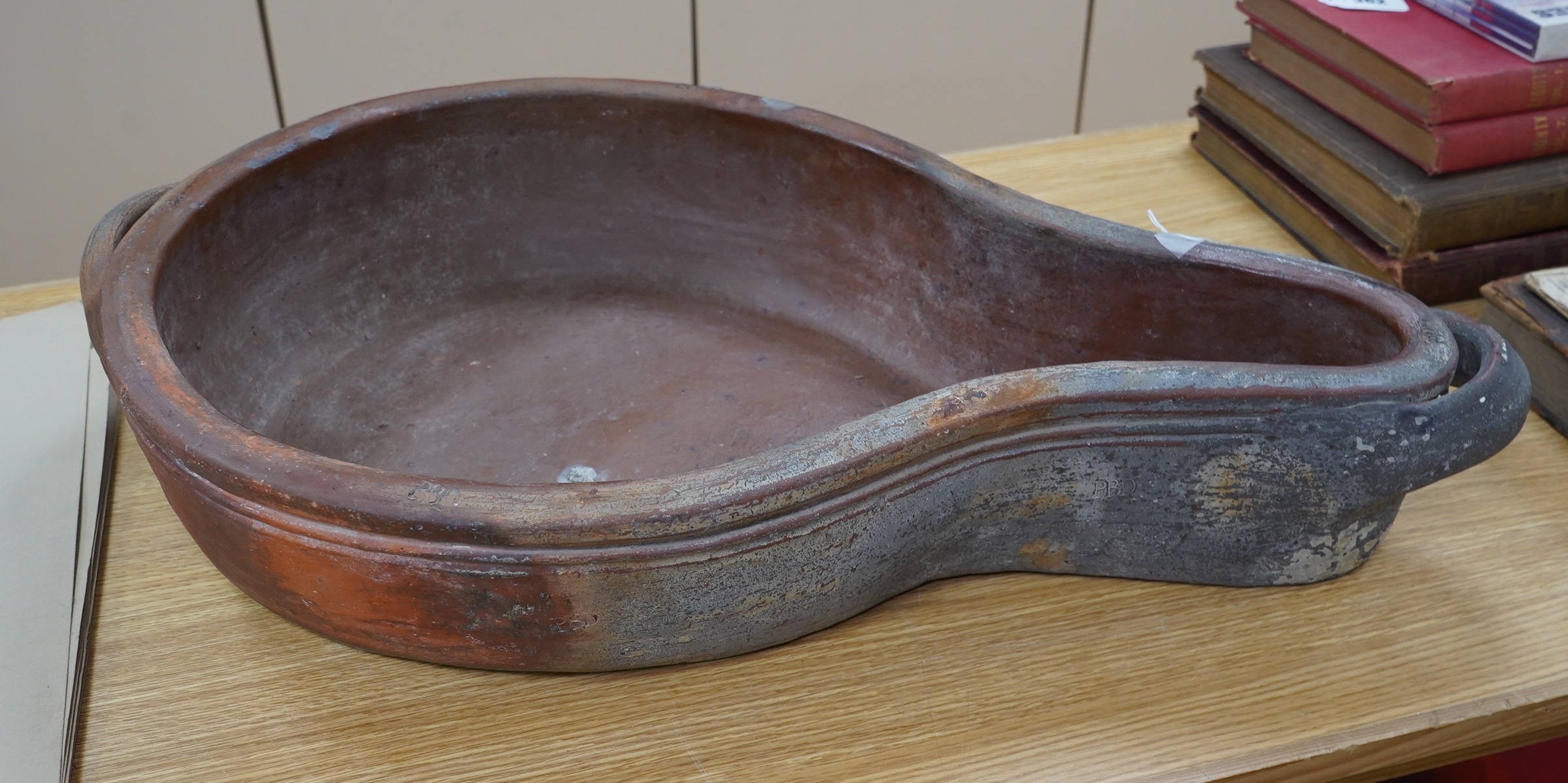 A 19th century French, ‘Saloir à Jambon’, shaped stoneware ham cooking vessel, 70cm long including handles. Stamp marks PBD to top edge and sides. Condition - good